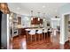 Spacious kitchen featuring a center island with seating, stainless appliances, and wood floors at 10587 Proposal Pointe Way, Fishers, IN 46040