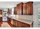 This kitchen features stainless steel appliances, stone countertops, and wood cabinets at 10587 Proposal Pointe Way, Fishers, IN 46040