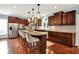 Spacious kitchen featuring an island with seating, stainless appliances, and custom wood cabinets at 10587 Proposal Pointe Way, Fishers, IN 46040