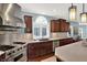 This bright kitchen features stainless steel appliances and custom cabinets at 10587 Proposal Pointe Way, Fishers, IN 46040