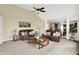 Spacious living room featuring neutral walls, plush carpet, ceiling fan and large windows for ample natural light at 10587 Proposal Pointe Way, Fishers, IN 46040