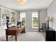 Well-lit office with built-in bookshelves, a spacious desk, and views of the outdoors at 10587 Proposal Pointe Way, Fishers, IN 46040
