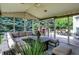Relaxing screened-in porch area with comfortable seating, table and chairs at 10587 Proposal Pointe Way, Fishers, IN 46040