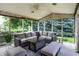 Relaxing screened-in porch area with comfortable seating and nature views at 10587 Proposal Pointe Way, Fishers, IN 46040