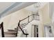 Elegant staircase with wood railings, white spindles, neutral walls, and a modern chandelier at 10587 Proposal Pointe Way, Fishers, IN 46040