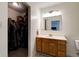 Bathroom featuring wood cabinets, a sink, a mirror, and an adjacent closet with ample storage space at 1059 Wild Ivy Trl, Franklin, IN 46131