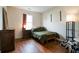 Cozy bedroom featuring hardwood floors, a comfortable bed, and a neutral color scheme at 1059 Wild Ivy Trl, Franklin, IN 46131