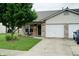 Charming brick home featuring a well-manicured lawn and attached two car garage at 1059 Wild Ivy Trl, Franklin, IN 46131