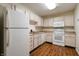 Functional kitchen featuring white appliances, laminate countertops, and plenty of storage space at 1059 Wild Ivy Trl, Franklin, IN 46131