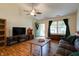 Cozy living room with hardwood floors, a ceiling fan, and plenty of natural light at 1059 Wild Ivy Trl, Franklin, IN 46131