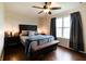Bright primary bedroom suite with a ceiling fan, natural light, and dark wood furniture at 1059 Wild Ivy Trl, Franklin, IN 46131