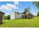 Backyard with deck, lush lawn, and mature trees, ideal for outdoor activities at 1103 Rosengarten Dr, Greenwood, IN 46142