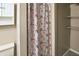 Bathroom with floral shower curtain, cabinet space, and shelving at 1103 Rosengarten Dr, Greenwood, IN 46142