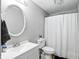 Well-lit bathroom with a toilet, vanity, mirror and shower at 1103 Rosengarten Dr, Greenwood, IN 46142