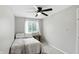 Bright bedroom featuring a ceiling fan, window, and neutral carpet at 1103 Rosengarten Dr, Greenwood, IN 46142