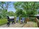 Wooden deck with grill, chairs, and wooded views. Perfect for outdoor entertaining at 1103 Rosengarten Dr, Greenwood, IN 46142