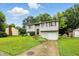Well-maintained two-story home with a lush green lawn, small storage shed, and concrete driveway at 1103 Rosengarten Dr, Greenwood, IN 46142