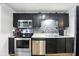 Kitchen features stainless appliances, black cabinets, and stainless steel sink at 1103 Rosengarten Dr, Greenwood, IN 46142