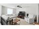 Inviting living room with a large gray sectional sofa, ceiling fan, and neutral decor at 1103 Rosengarten Dr, Greenwood, IN 46142