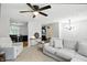 Cozy living area featuring a comfy sofa and chair, open to the dining area, with a ceiling fan at 1103 Rosengarten Dr, Greenwood, IN 46142