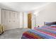 Bedroom featuring double closets, cozy carpet, and a brightly patterned blanket at 11529 Sunset Cove Ln # 11529, Indianapolis, IN 46236