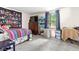 Comfortable bedroom with a large window, dresser, and colorful tapestry and decor at 11529 Sunset Cove Ln # 11529, Indianapolis, IN 46236