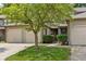 Lovely exterior of a multi-unit home featuring well-manicured lawns, mature shade tree, and attached garages at 11529 Sunset Cove Ln # 11529, Indianapolis, IN 46236