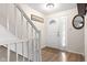 Bright foyer with a staircase, featuring wood floors, fresh paint, and a charming front door with sidelight at 11529 Sunset Cove Ln # 11529, Indianapolis, IN 46236