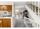 Open-concept living room and kitchen area with plush carpeting, a bar, and an adjoining great room at 11529 Sunset Cove Ln # 11529, Indianapolis, IN 46236