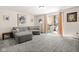Bright living room featuring plush carpeting, comfortable seating, and sliding doors leading to the outside at 11529 Sunset Cove Ln # 11529, Indianapolis, IN 46236