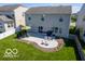 Aerial view shows a home's backyard featuring a patio with lounge chairs and an umbrella at 12584 Cold Stream Rd, Noblesville, IN 46060