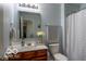 Well-lit bathroom with vanity and modern fixtures, including a shower with patterned curtain at 12584 Cold Stream Rd, Noblesville, IN 46060