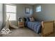 Comfortable bedroom with a blue comforter, playful teepee, and natural light at 12584 Cold Stream Rd, Noblesville, IN 46060