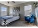 Bright bedroom with ceiling fan, multiple windows, and a cozy armchair at 12584 Cold Stream Rd, Noblesville, IN 46060