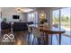 Open dining area with a wooden table and chairs that leads to the living room and backyard at 12584 Cold Stream Rd, Noblesville, IN 46060