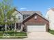 Charming two-story home featuring a brick front, two-car garage, and well-manicured lawn at 12584 Cold Stream Rd, Noblesville, IN 46060