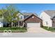 Charming two-story home featuring a brick front, two-car garage, and well-manicured lawn at 12584 Cold Stream Rd, Noblesville, IN 46060