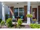 Inviting front porch with a seating area and tastefully landscaped garden bed at 12584 Cold Stream Rd, Noblesville, IN 46060