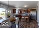 Kitchen and dining area featuring wood cabinets, stainless steel appliances, and a breakfast bar at 12584 Cold Stream Rd, Noblesville, IN 46060