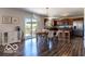Open concept kitchen and dining area with hardwood floors and stainless steel appliances at 12584 Cold Stream Rd, Noblesville, IN 46060