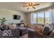 Cozy living room with plush seating, a TV, and large window overlooking the backyard at 12584 Cold Stream Rd, Noblesville, IN 46060