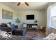 Inviting living room featuring a TV, neutral decor, and a large window for natural light at 12584 Cold Stream Rd, Noblesville, IN 46060