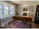 Comfortable home office featuring a large desk and natural light from a large window at 12584 Cold Stream Rd, Noblesville, IN 46060