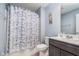 Well-lit bathroom with a shower, stylish shower curtain, and modern vanity with ample counter space at 12634 Mustard Seed Ct, Fishers, IN 46038