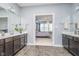 Bathroom view showing double sinks, granite counters, and access to the main bedroom at 12634 Mustard Seed Ct, Fishers, IN 46038