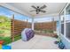 Covered patio featuring a ceiling fan, and wooden privacy screen at 12634 Mustard Seed Ct, Fishers, IN 46038