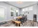 Bright dining room features a wood table with a bench and sleek black chairs under a modern chandelier at 12634 Mustard Seed Ct, Fishers, IN 46038