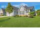 Well-maintained home exterior with green lawn, shrubbery and mature tree at 12634 Mustard Seed Ct, Fishers, IN 46038
