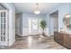 Bright foyer with hardwood floors, white trim and a decorative front door at 12634 Mustard Seed Ct, Fishers, IN 46038
