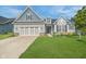 Charming two-story home with a well-manicured lawn and a two-car garage at 12634 Mustard Seed Ct, Fishers, IN 46038